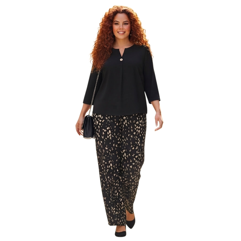 Modelo con conjunto Ibravacr de blusa negra y pantalones de pierna ancha con estampado abstracto y corte fluido.