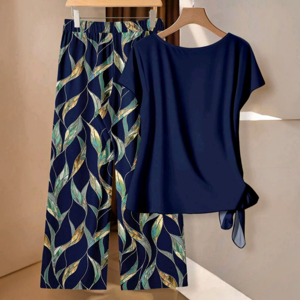 Conjunto de dos piezas Ibravacr con blusa azul marino de nudo lateral y pantalones de pierna ancha con estampado botánico