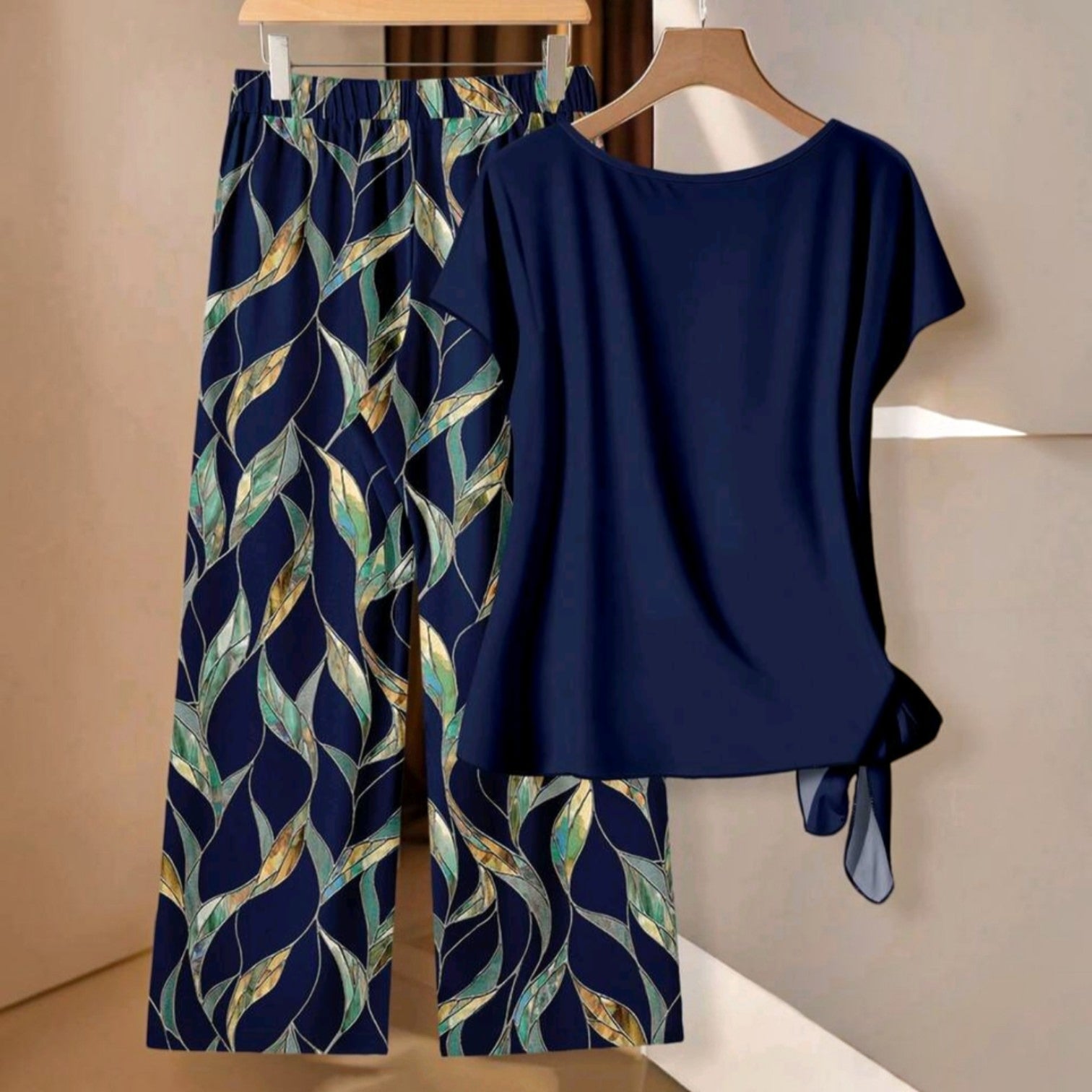 Conjunto de dos piezas Ibravacr con blusa azul marino de nudo lateral y pantalones de pierna ancha con estampado botánico