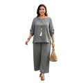 Modelo vistiendo conjunto Ibravacr de dos piezas gris con blusa holgada y pantalón ancho de tela suave y transpirable.