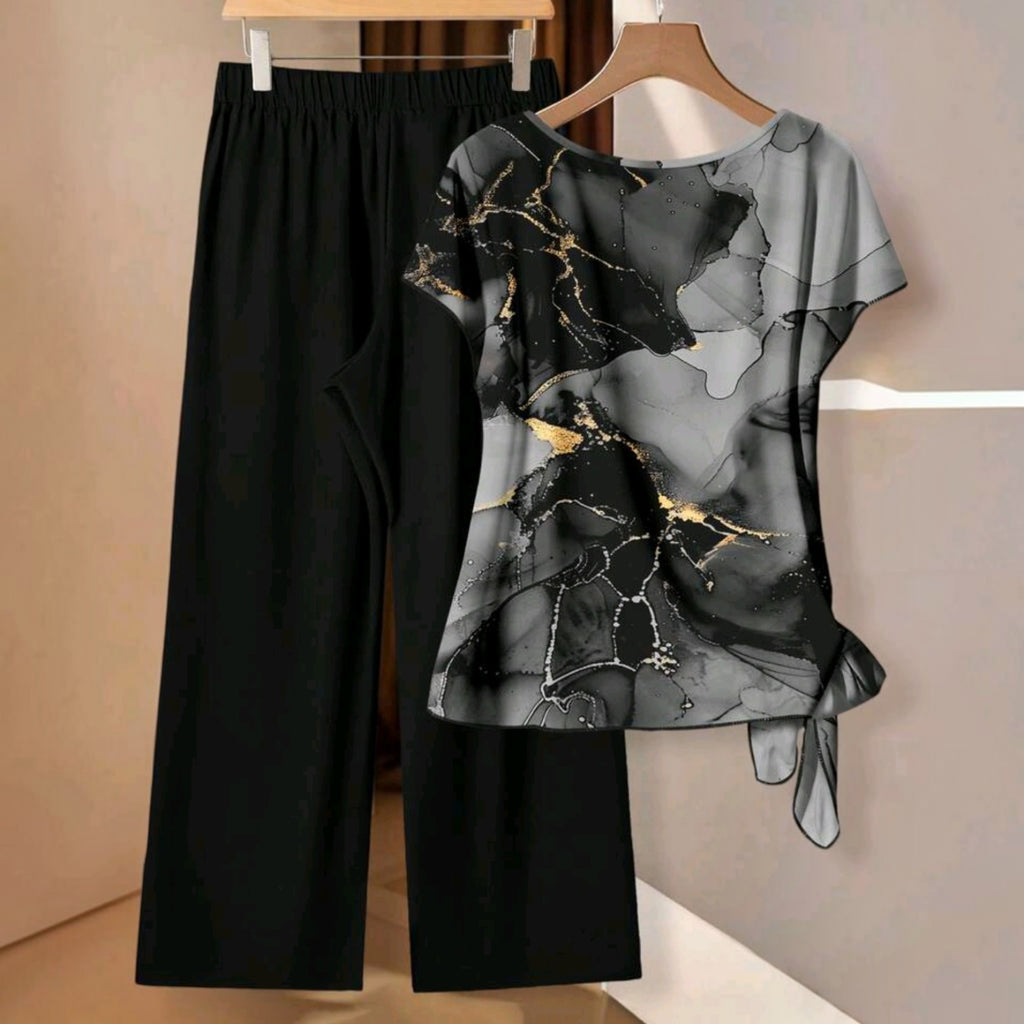 Conjunto Ibravacr de blusa con estampado abstracto gris y dorado y pantalón negro de pierna ancha con nudo lateral