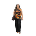 Mujer sonriente vistiendo conjunto Ibravacr de blusa sin mangas con estampado floral naranja y pantalón negro recto.