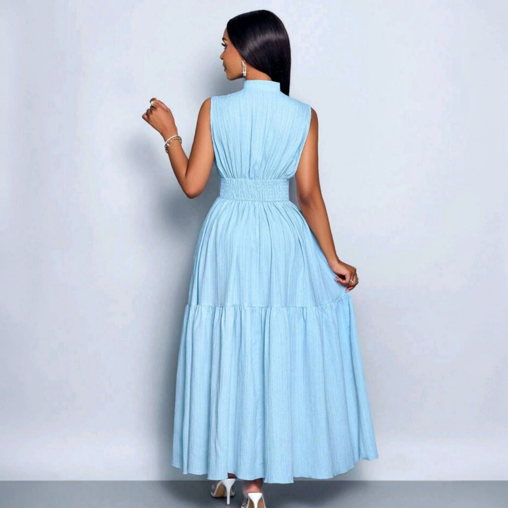 Modelo de espaldas vistiendo un vestido largo Ibravacr azul cielo sin mangas con cuello alto y falda de niveles.