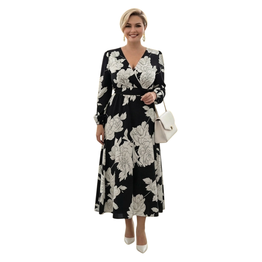 Modelo sonriente usando vestido midi Ibravacr con estampado floral blanco y negro, escote cruzado y mangas largas.