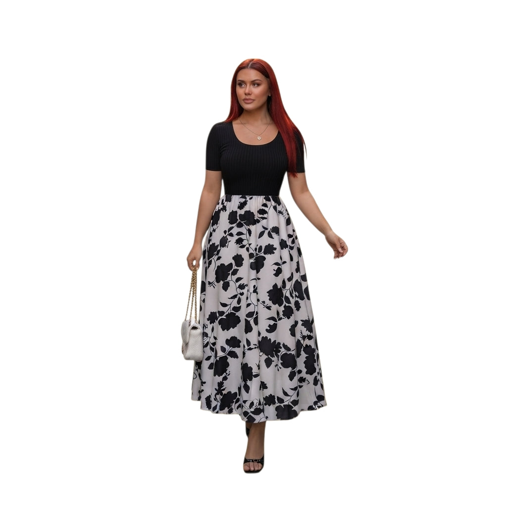 Modelo con vestido midi Ibravacr de dos piezas, top negro acanalado y falda acampanada con estampado floral blanco y negro