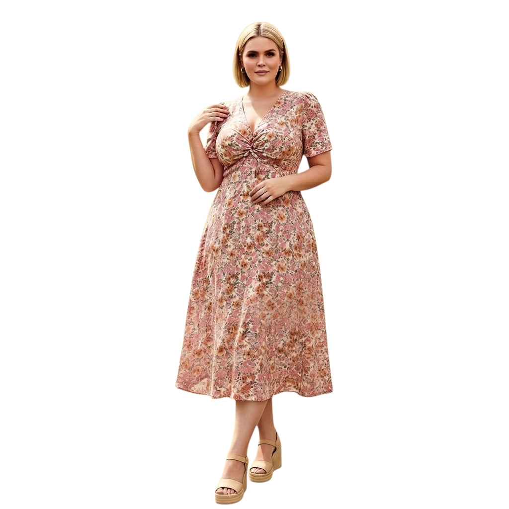 Modelo rubia vistiendo un vestido midi Ibravacr floral con escote en V y detalle de nudo frontal en tonos suaves.